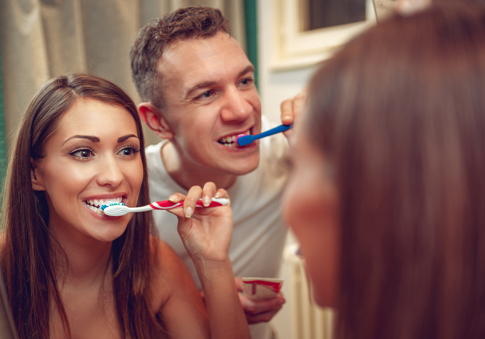 Couple brushing teeth in the morning