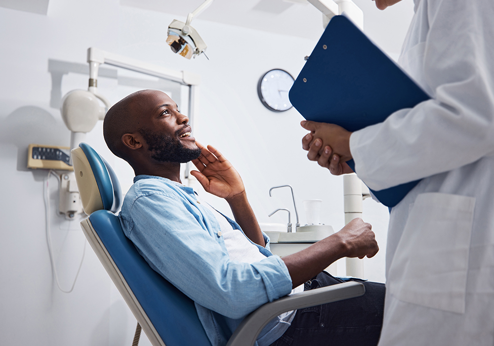 Man looking speaking with a dentist