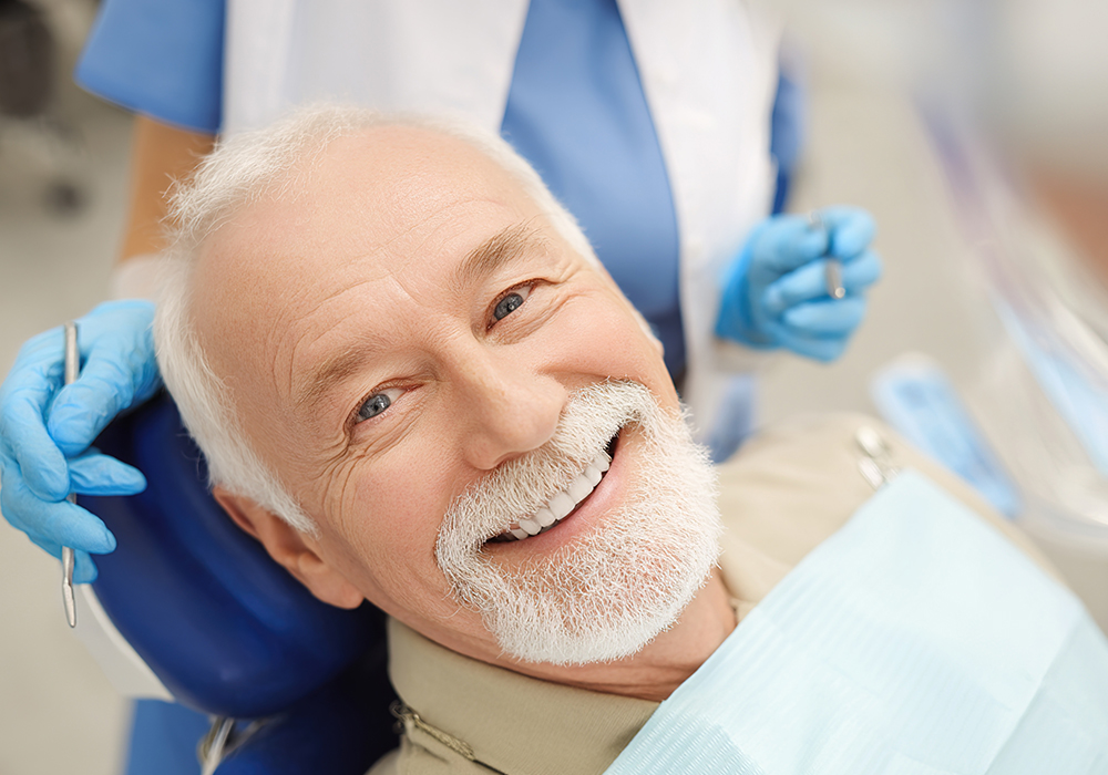 Male smiling a denture fitting