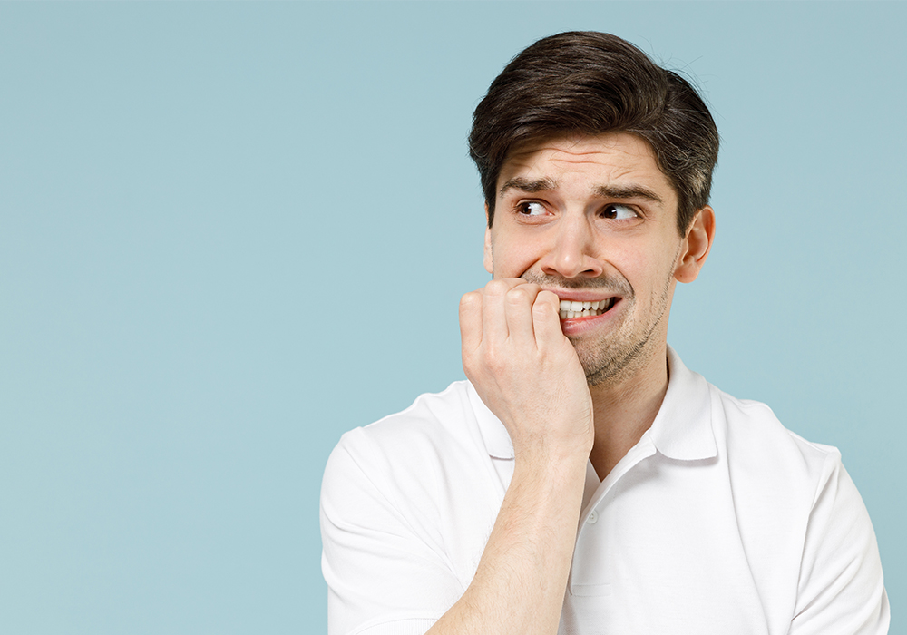 Man bitting his nails