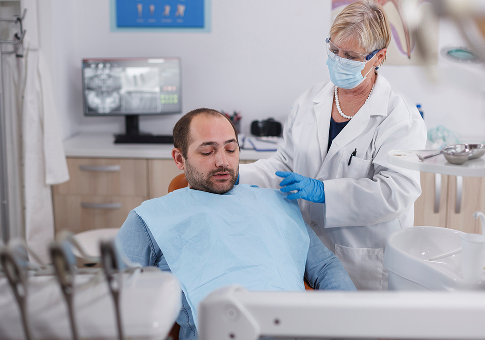 Man looking down while during a dental appointment with a dentist