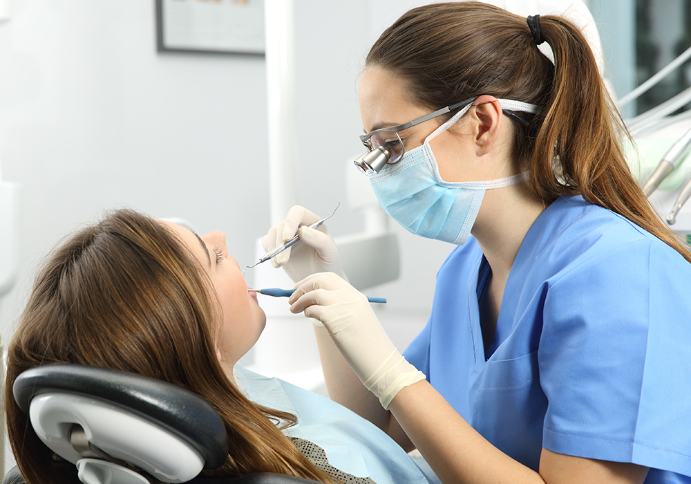 Woman smiling after denture fitting at dental office