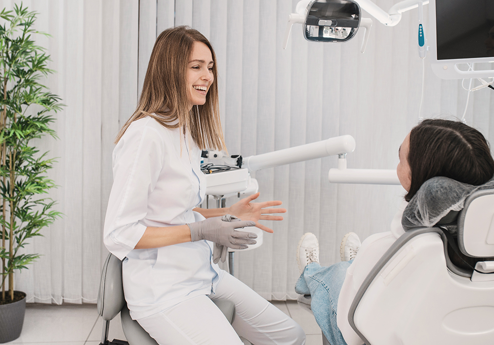 Woman speaking with her dentist in dental office.