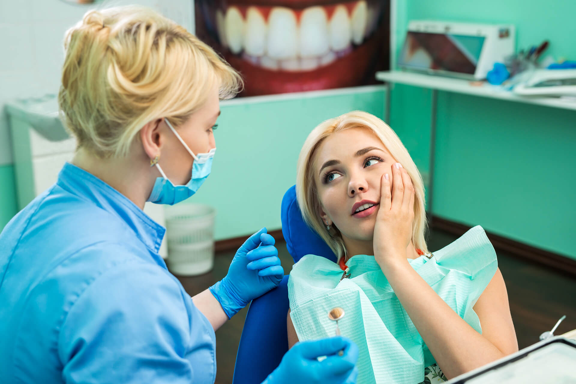 Woman speaking with a frontdesk worker in dental office