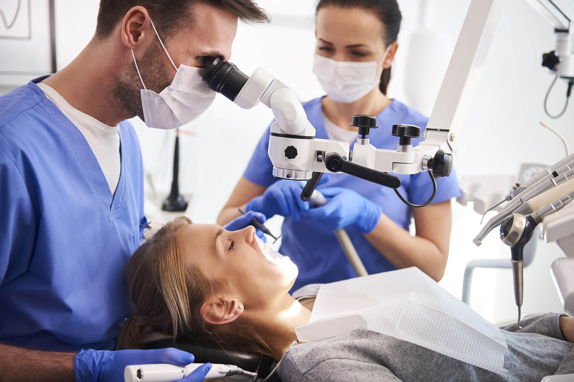 Dentist closely inspecting a patient’s teeth