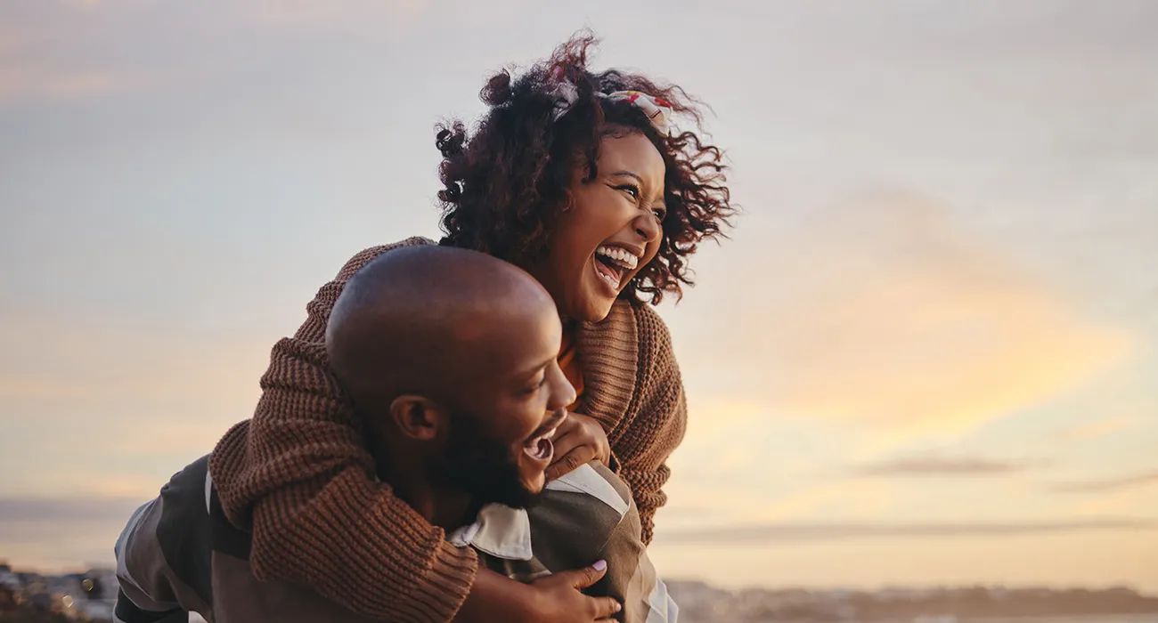 Black couple smiling while traveling together
