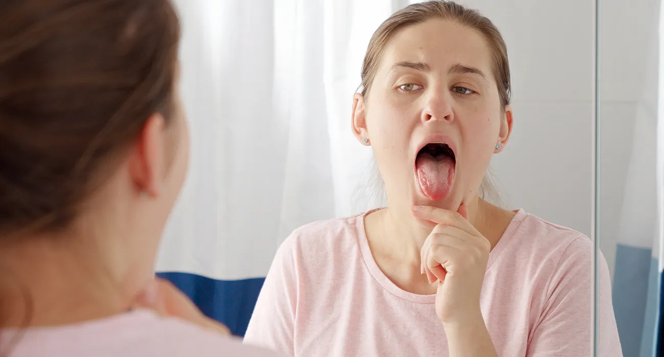 Woman looking inside her mouth