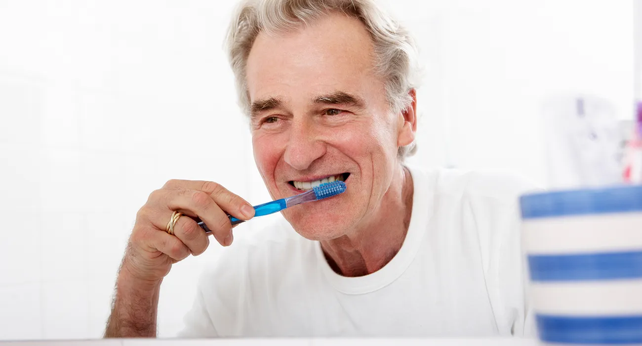 Senior brushing his teeth